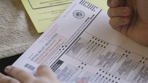 A person fills out an official ballot
